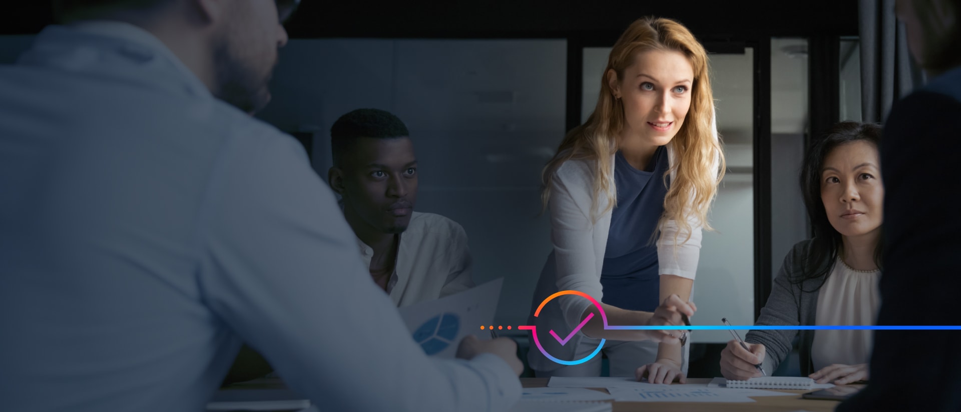 ​​​​Businesspeople collaborating around a table in a conference room.​​