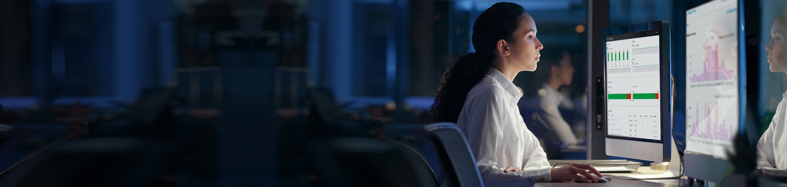 Office worker viewing double computer screens