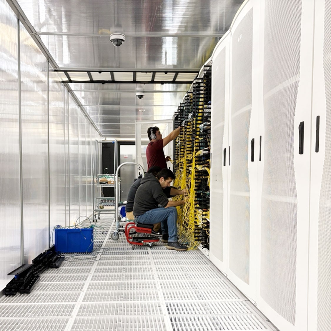 Technicians working on installing cables in a data center