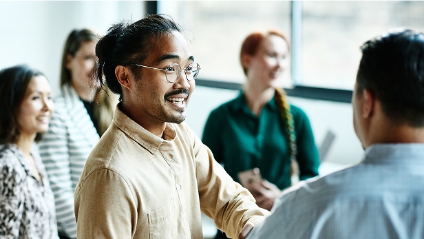 Businessman shaking hands with colleague after meeting in office