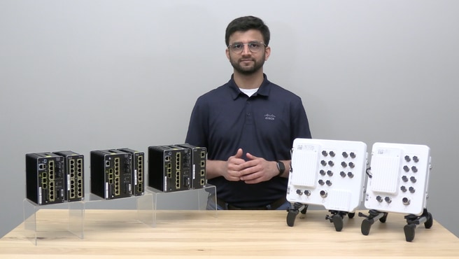 A Cisco product expert standing behind a table that displays Cisco IE3500 Rugged Series and IE3500 Heavy Duty Series switches