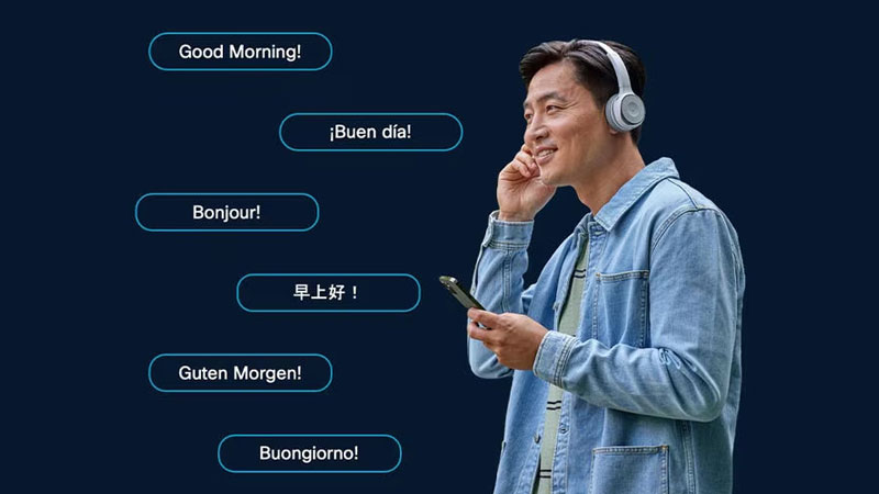 Person with headphones and phone surrounded by speech bubbles saying Good Morning!, ¡Buen día!, Bonjour!, 早上好 !, Guten Morgen!, and Buongiorno!