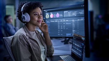  Engineer looking at network monitoring and observability dashboards