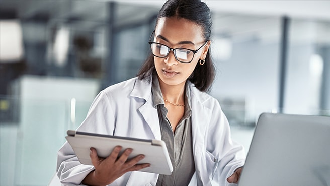 Clinician using tablet and computer