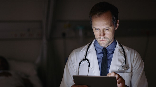 Clinician using tablet in patient room